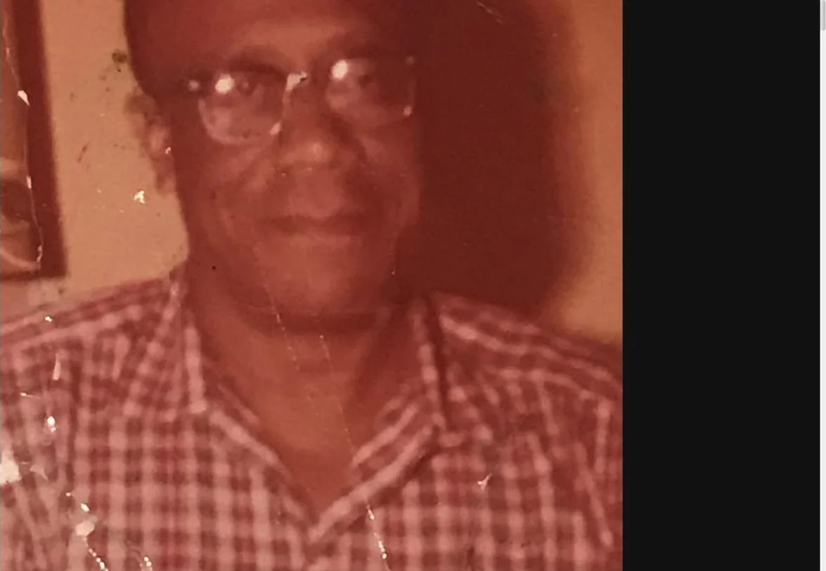 A treasured color photograph of a family elder wearing glasses