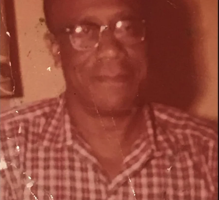 A treasured color photograph of a family elder wearing glasses