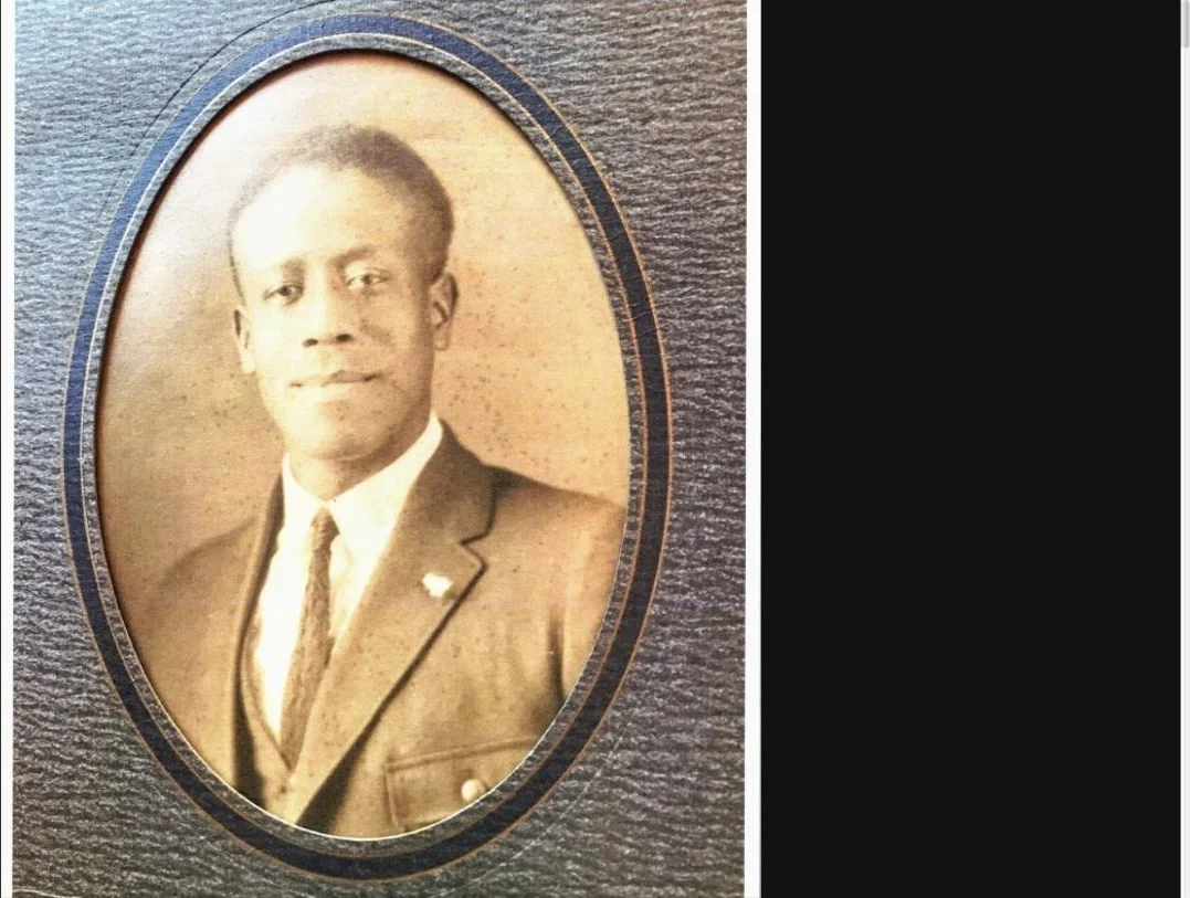 An oval studio portrait from the family album of a young man in a suit and tie