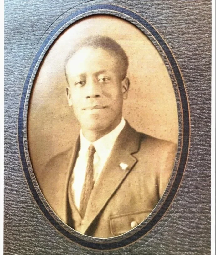 An oval studio portrait from the family album of a young man in a suit and tie
