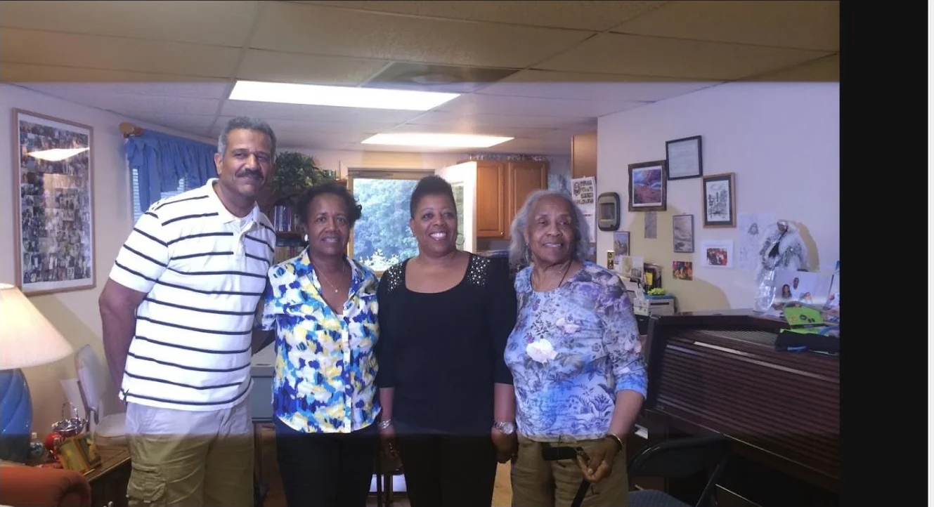 Four family members smiling together during a family visit