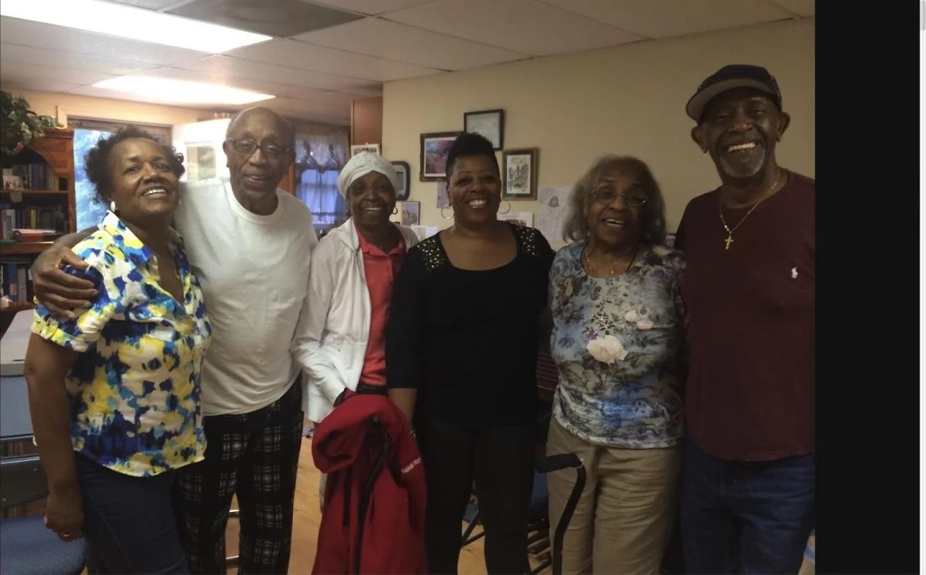 Six family members smiling together at a family visit