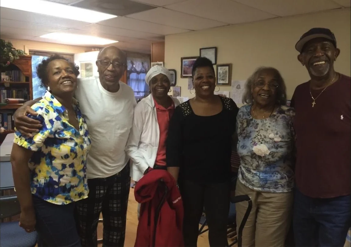 Six family members smiling together at a family visit